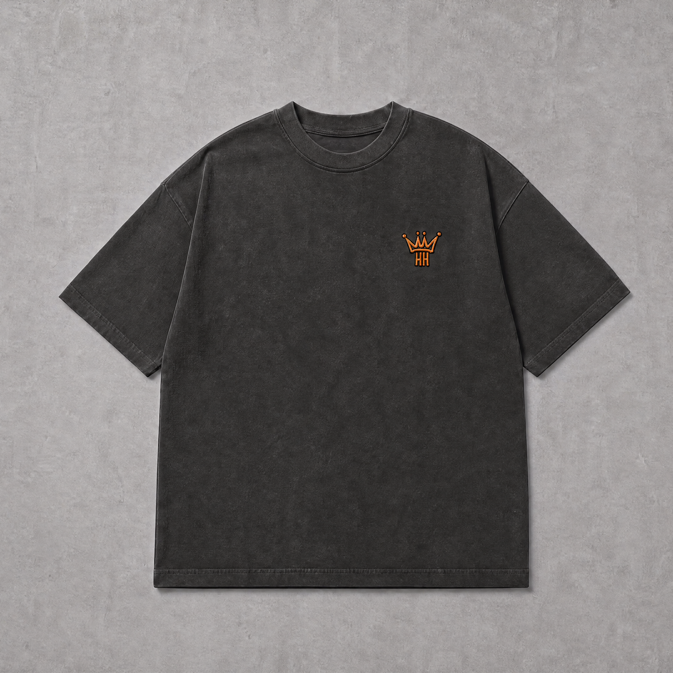 A dark charcoal gray short-sleeve t-shirt with a small orange embroidered crown logo on the left chest, displayed flat against a textured gray background.