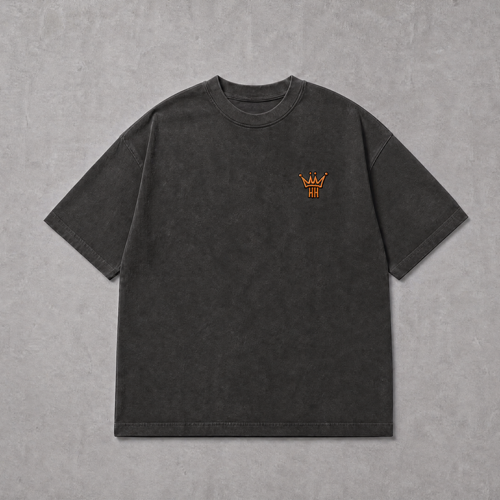 A dark charcoal gray short-sleeve t-shirt with a small orange embroidered crown logo on the left chest, displayed flat against a textured gray background.