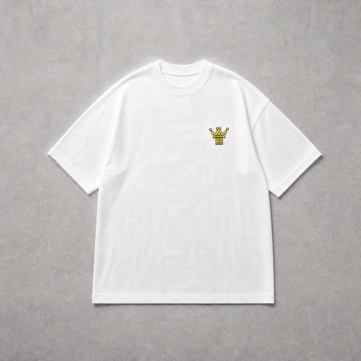 A white short-sleeve crewneck t-shirt with a small yellow graphic on the left chest, laid flat on a textured gray background.