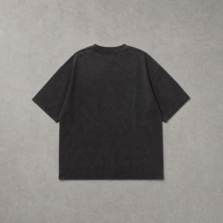 A dark charcoal gray short-sleeve t-shirt shown from the back, laid flat against a textured gray background.