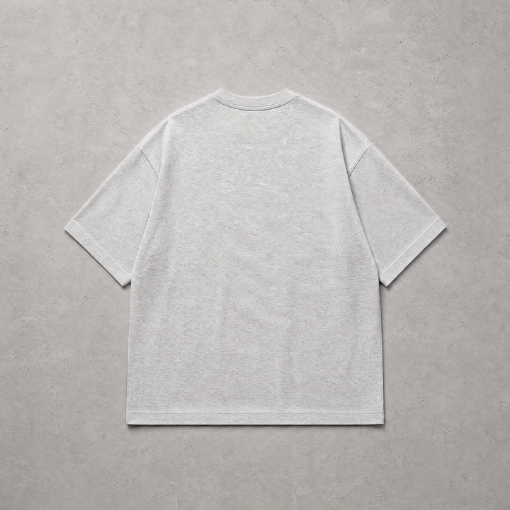 A light gray short-sleeve t-shirt shown from the back, laid flat on a textured gray background.
